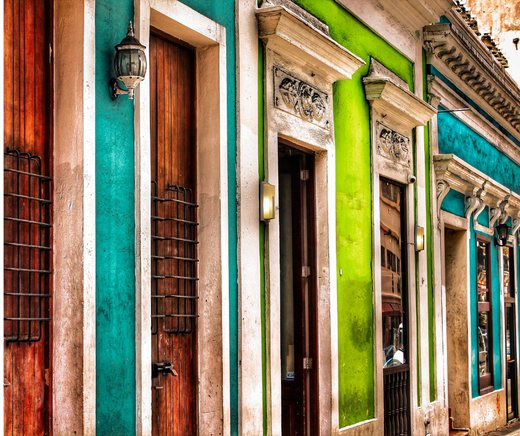 Turquoise, green, and wood doors along a colonial street in Old San Juan.